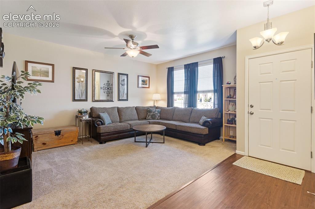 Image 7 of 26: The cozy covered front entryway offers a sitting area to enjoy the outdoors