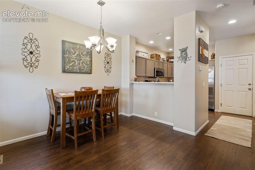 Image 9 of 26: The lovely, carpeted living room with ceiling fan is adjacent to dining are