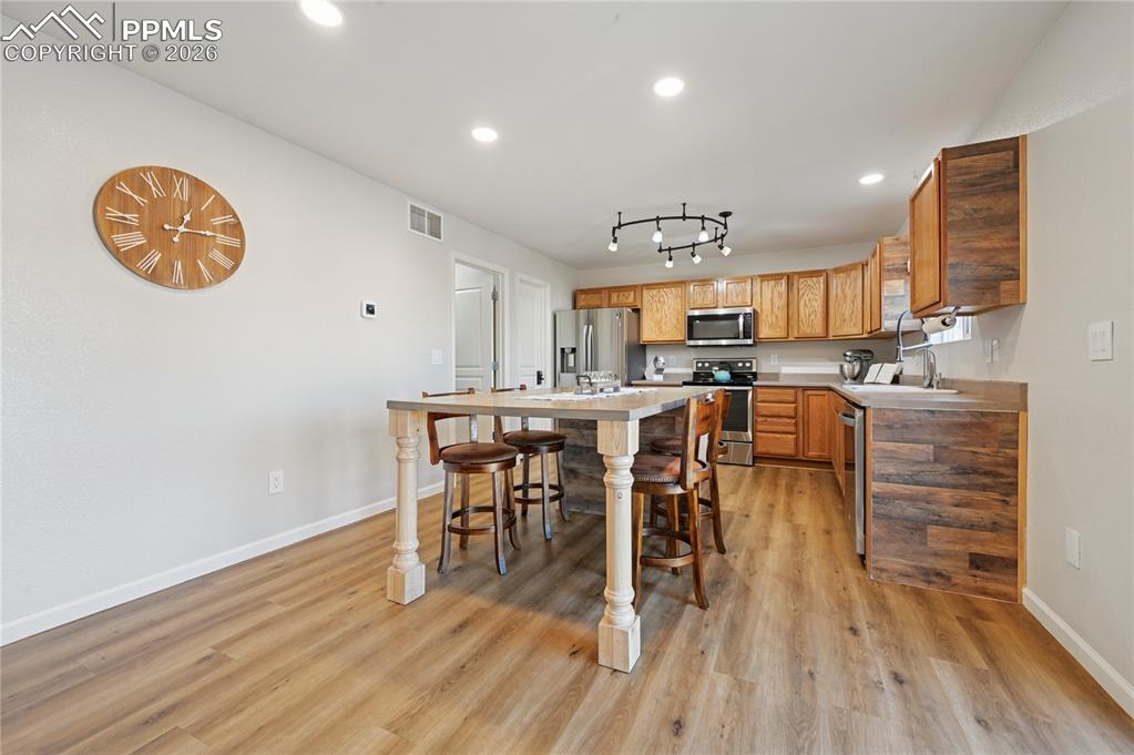 Image 12 of 37: Kitchen with light countertops, stainless steel appliances, recessed lighti