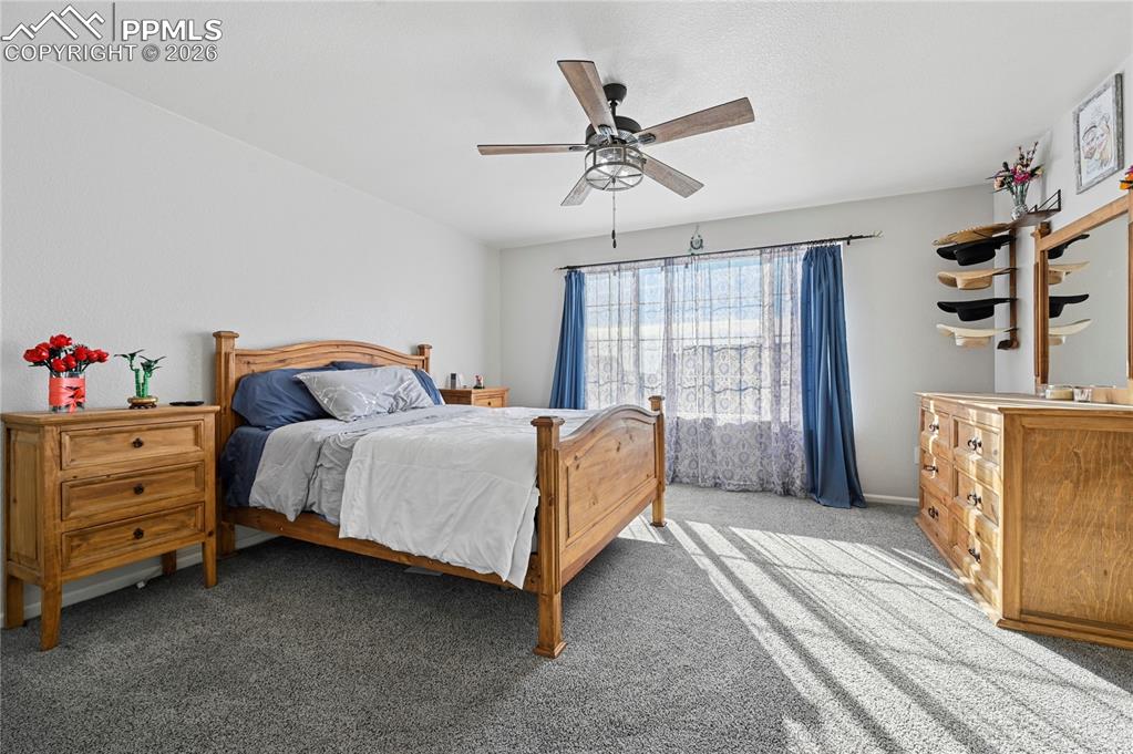 Image 16 of 37: Carpeted bedroom featuring a ceiling fan