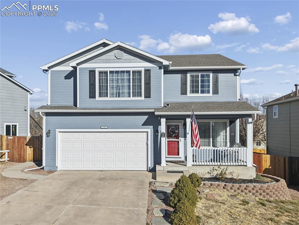 Image 2 of 37: Traditional-style home with a porch, an attached garage, concrete driveway,