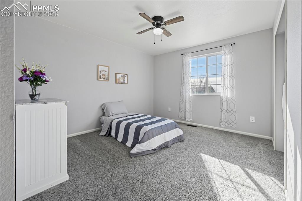 Image 23 of 37: Carpeted bedroom featuring ceiling fan and baseboards