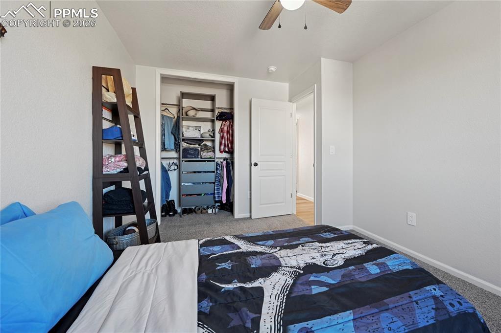 Image 26 of 37: Bedroom featuring light colored carpet, a ceiling fan, and a closet