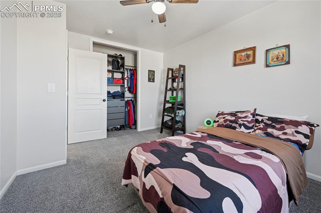Image 27 of 37: Bedroom with carpet floors, ceiling fan, and a closet