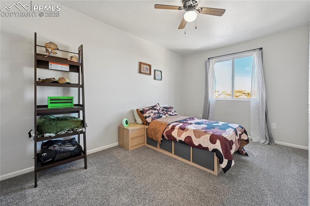 Image 28 of 37: Carpeted bedroom featuring a ceiling fan and baseboards