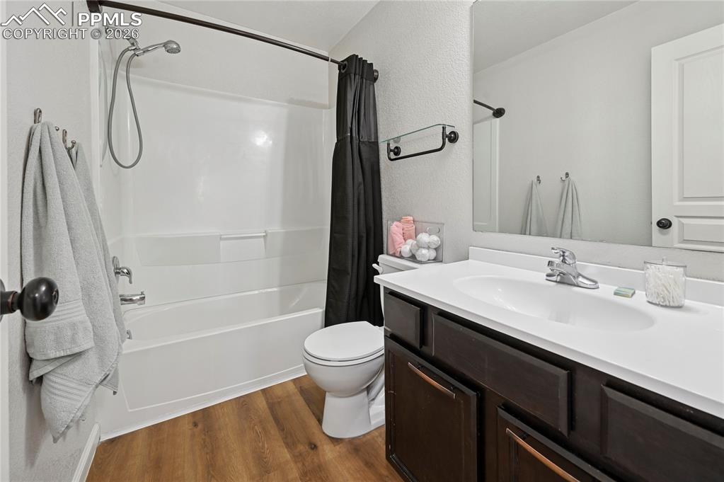 Image 29 of 37: Bathroom featuring vanity, dark wood-style floors, shower / bath combo, and