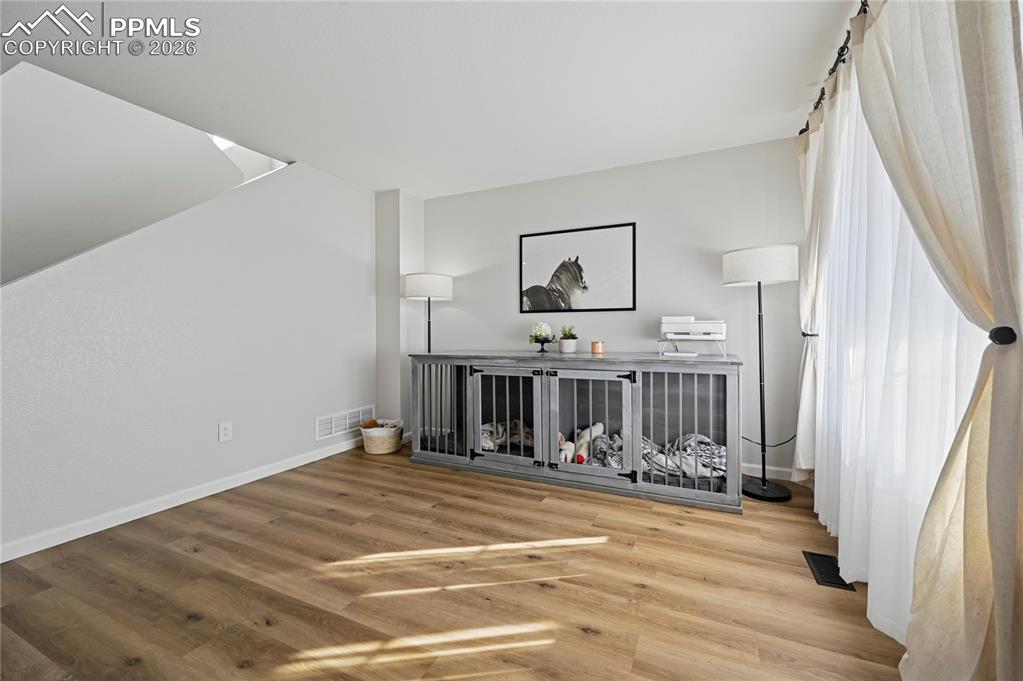 Image 5 of 37: Unfurnished living room featuring wood finished floors and baseboards