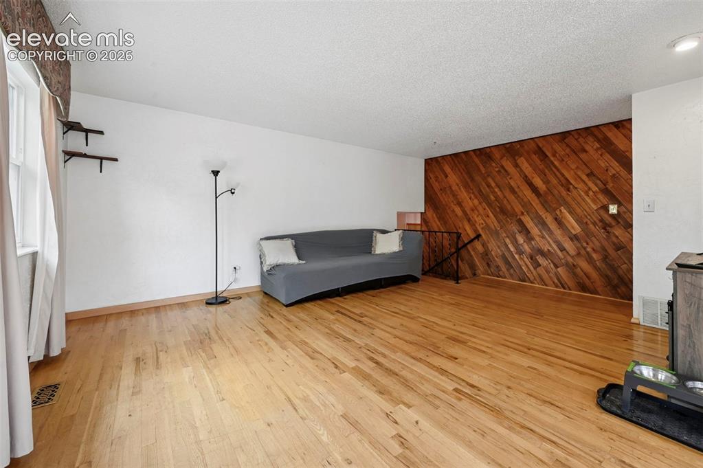 Image 32 of 50: Light wood-finish flooring complements a distinctive diagonal wood-paneled