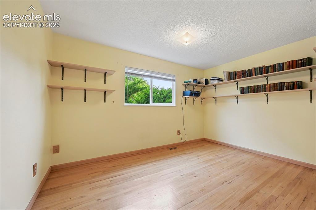 Image 37 of 50: Room featuring light wood-finish flooring and a neutral-toned wall color