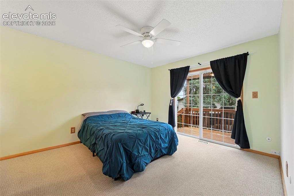 Image 39 of 50: Room featuring light green walls, beige carpeting, and a white ceiling fan