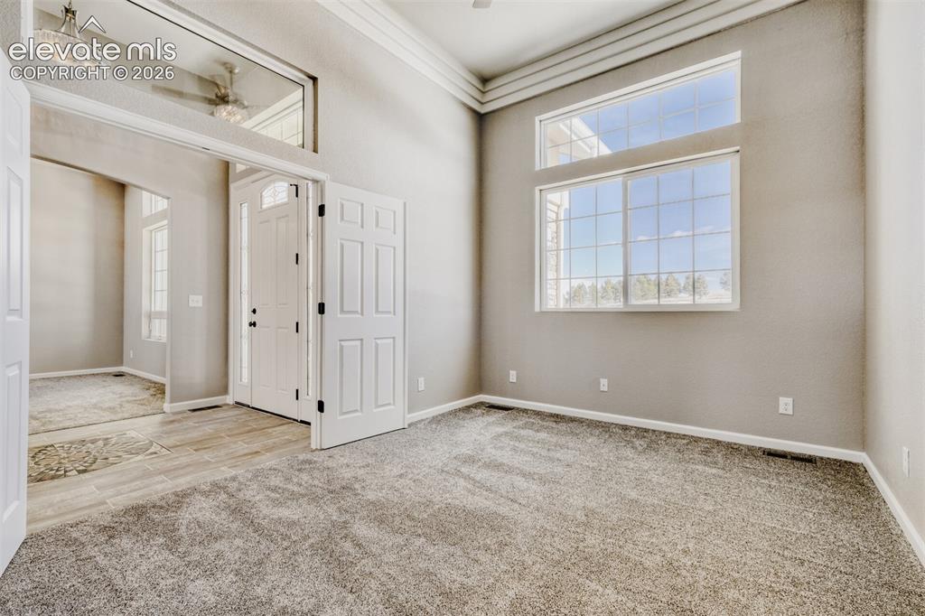 Image 16 of 50: Secondary Bedroom #1 or Office off the front door with full bath.