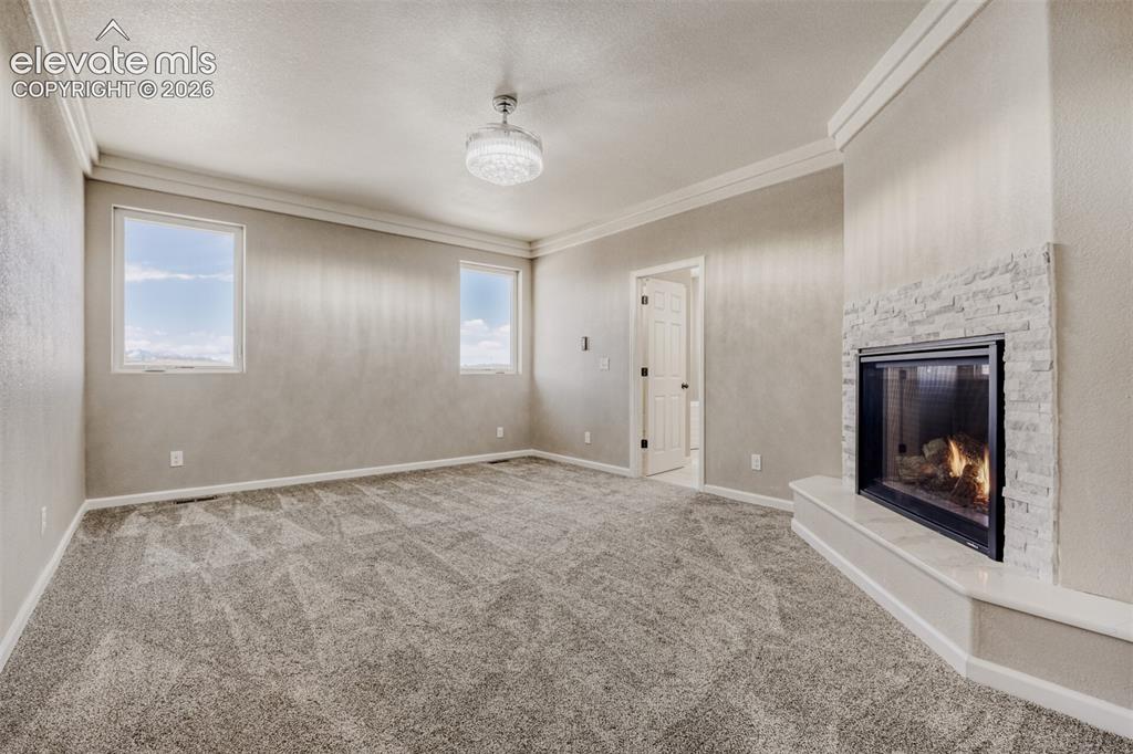 Image 19 of 50: Primary Bedroom with fireplace, massive closet, lux 5-piece bath