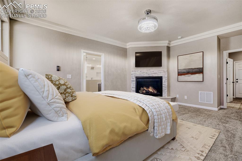 Image 20 of 47: Virtually staged primary Bedroom with fireplace, massive closet, lux 5-piec