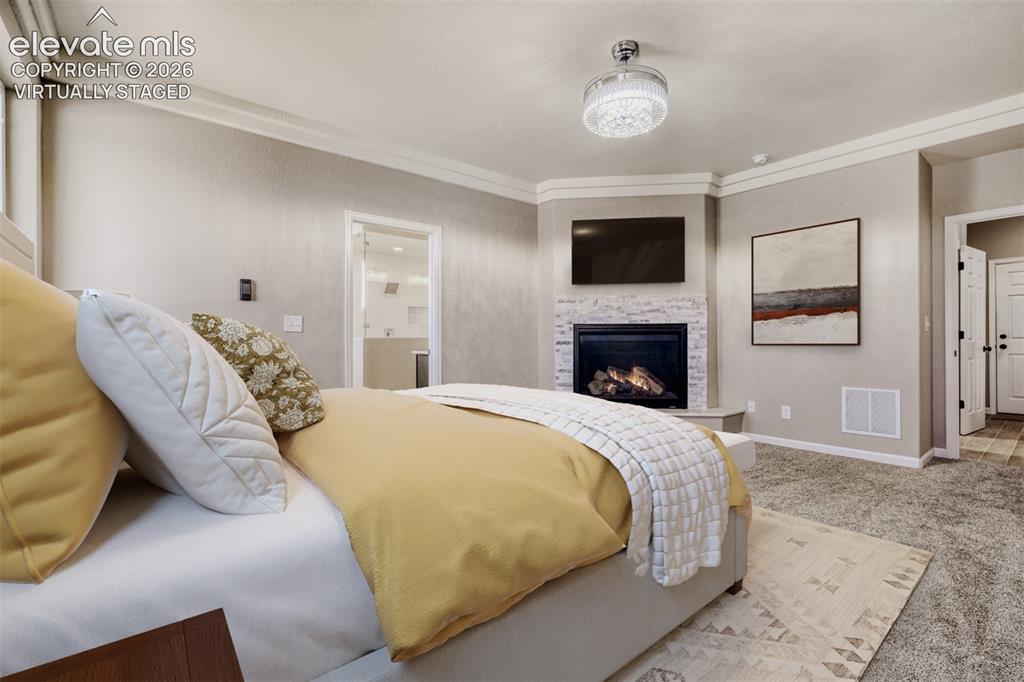 Image 20 of 50: Virtually staged primary Bedroom with fireplace, massive closet, lux 5-piec