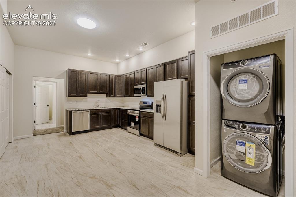 Image 33 of 50: Kitchenette with second laundry