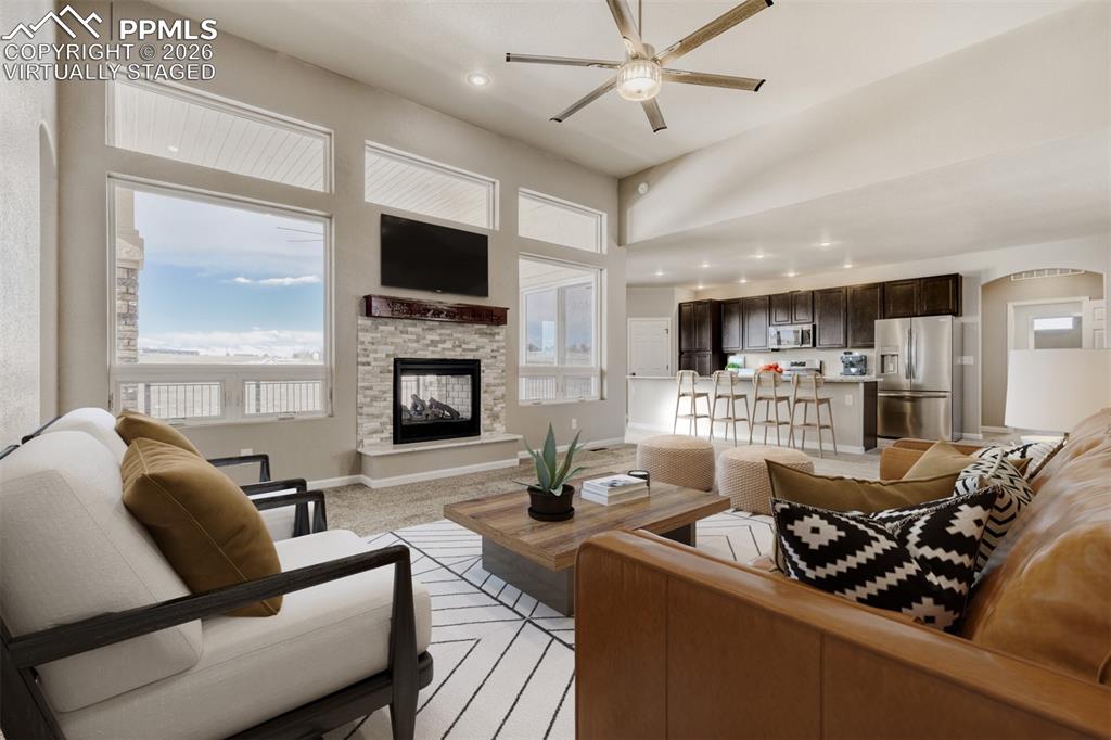 Image 7 of 47: Virtually staged Living Room with open concept and covered deck.