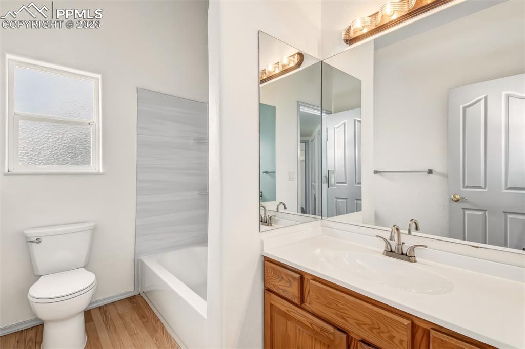Image 15 of 35: Bathroom with vanity, light wood-type flooring, and shower / bath combinati