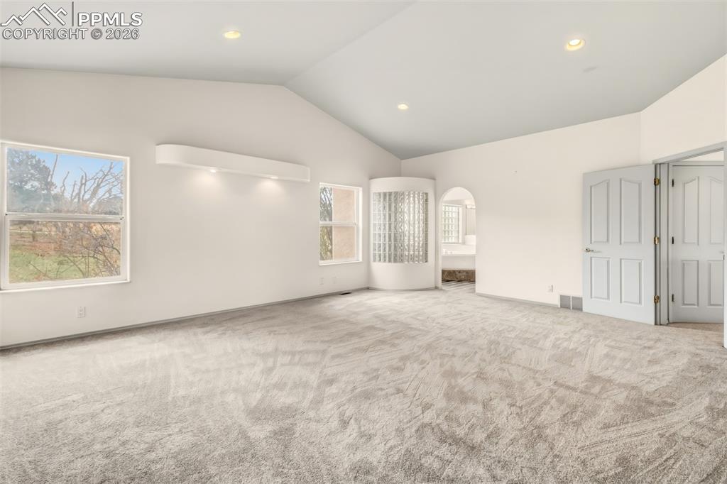 Image 20 of 35: Unfurnished bedroom featuring carpet flooring and a high ceiling