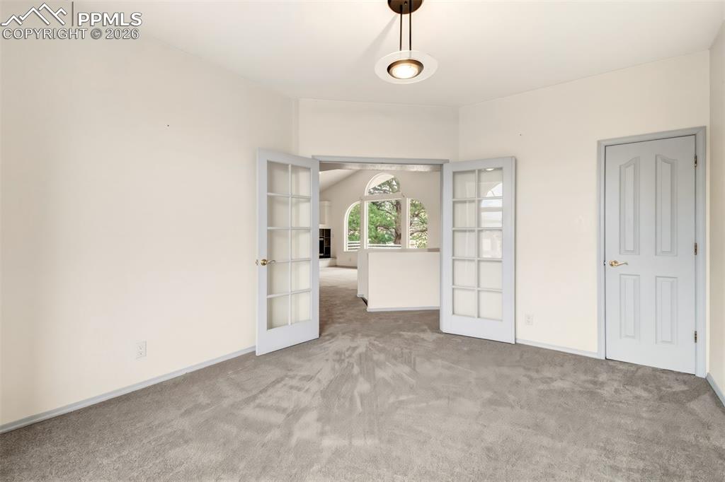 Image 25 of 35: Unfurnished office with carpet floors and french doors