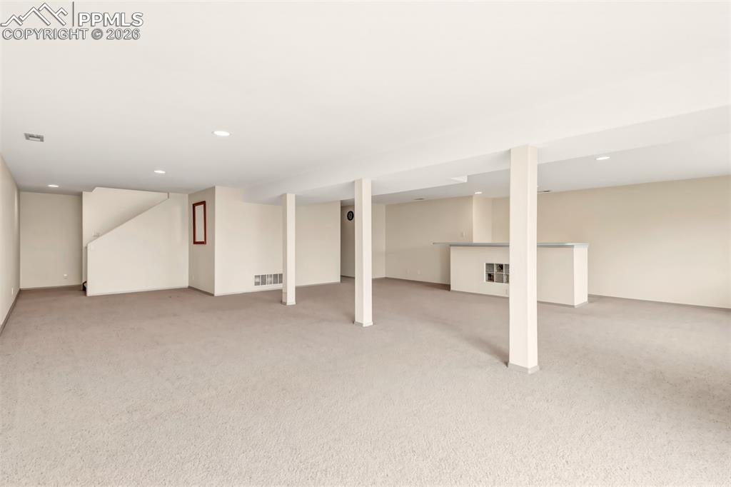 Image 29 of 35: Finished below grade area featuring light carpet and recessed lighting