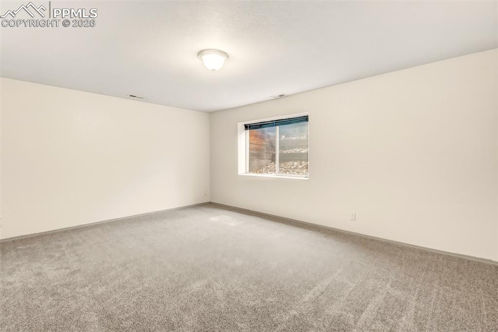 Image 32 of 35: Spare room with carpet floors