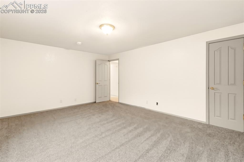 Image 33 of 35: Unfurnished room with carpet flooring