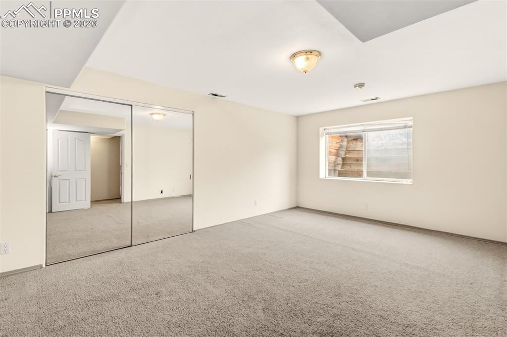 Image 34 of 35: Unfurnished bedroom with carpet flooring and a closet