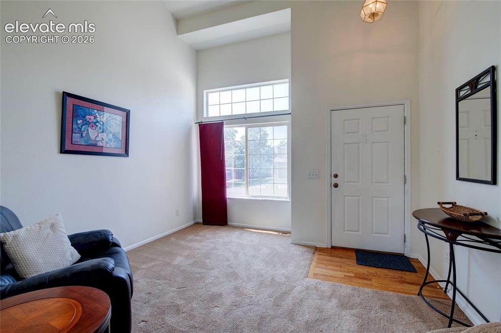 Image 12 of 34: Entry area with vaulted ceiling, large windows, transom window, recessed en