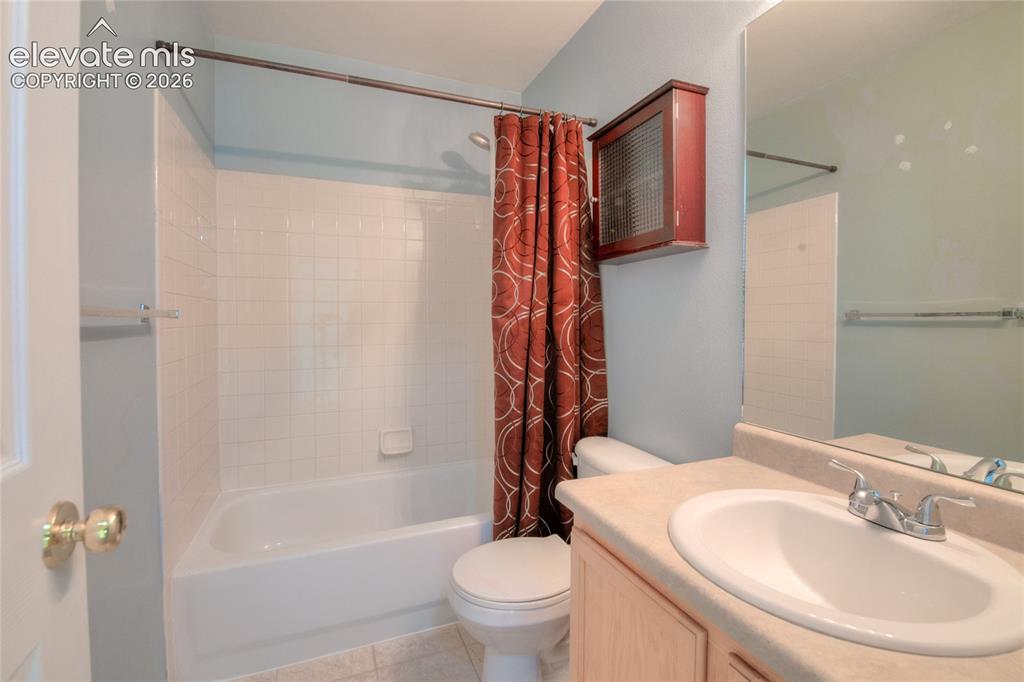 Image 24 of 34: Full bathroom featuring a single vanity with a laminate countertop, an inte