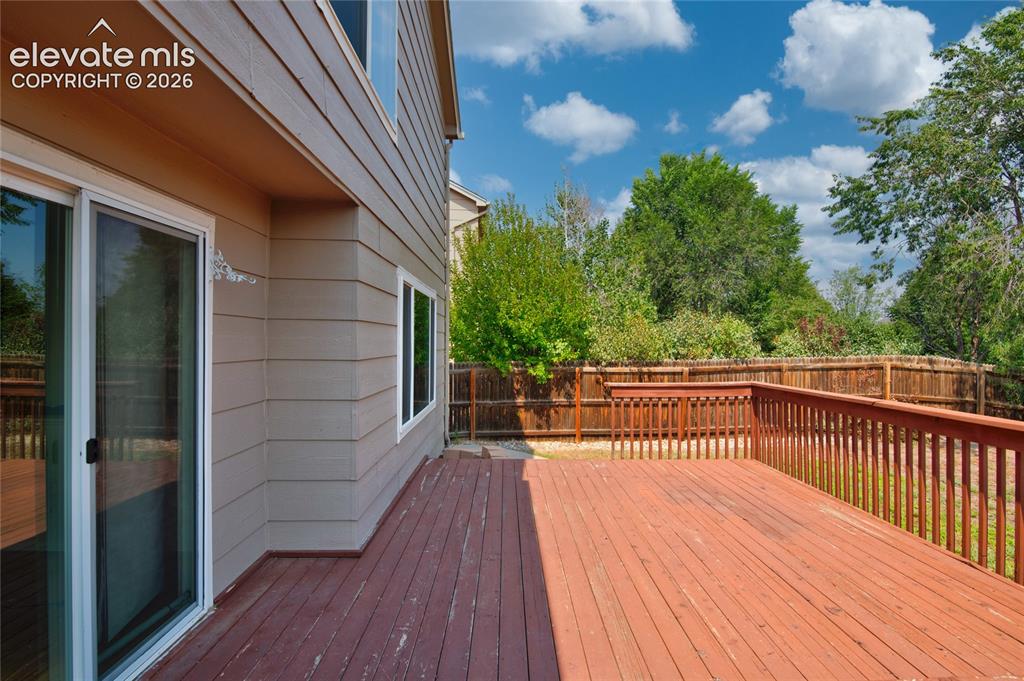 Image 32 of 34: Expansive wood deck with a perimeter railing, offering outdoor living space