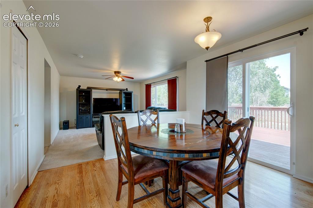 Image 6 of 34: Dining area featuring wood-finish flooring, a brass-finish ceiling light fi