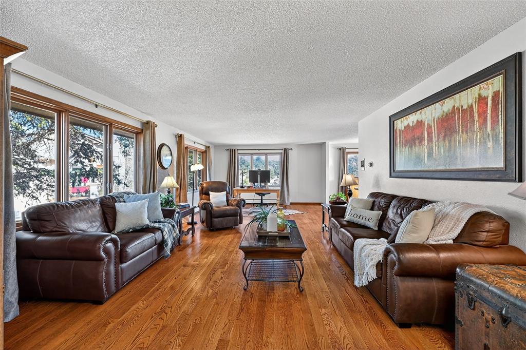 Image 18 of 48: Spacious loving room with many windows!