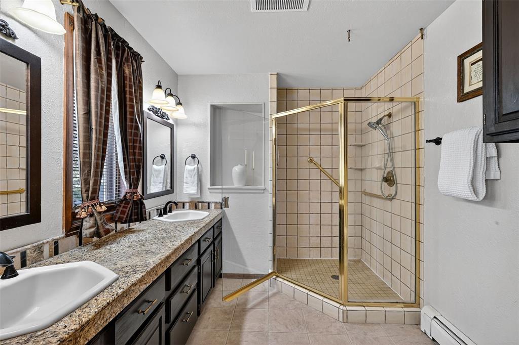 Image 29 of 48: Beautiful master bath with two sinks, granite counters and large shower!
