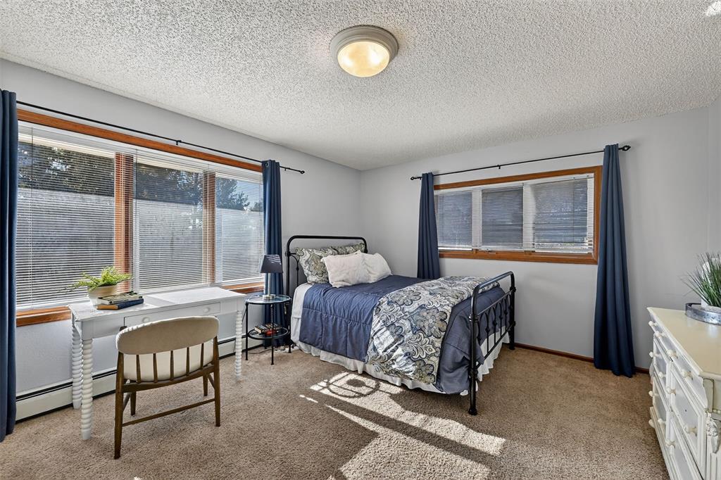 Image 30 of 48: Spacious secondary bedroom on the main level with views of the front range!