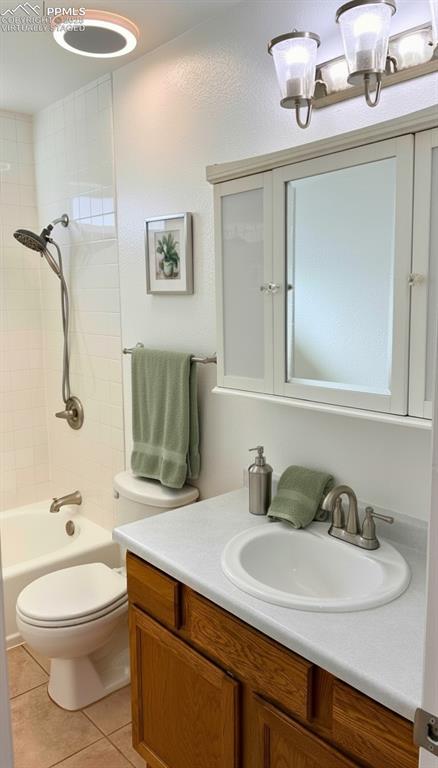 Image 14 of 34: Full bathroom featuring vanity, light tile patterned floors, and washtub /