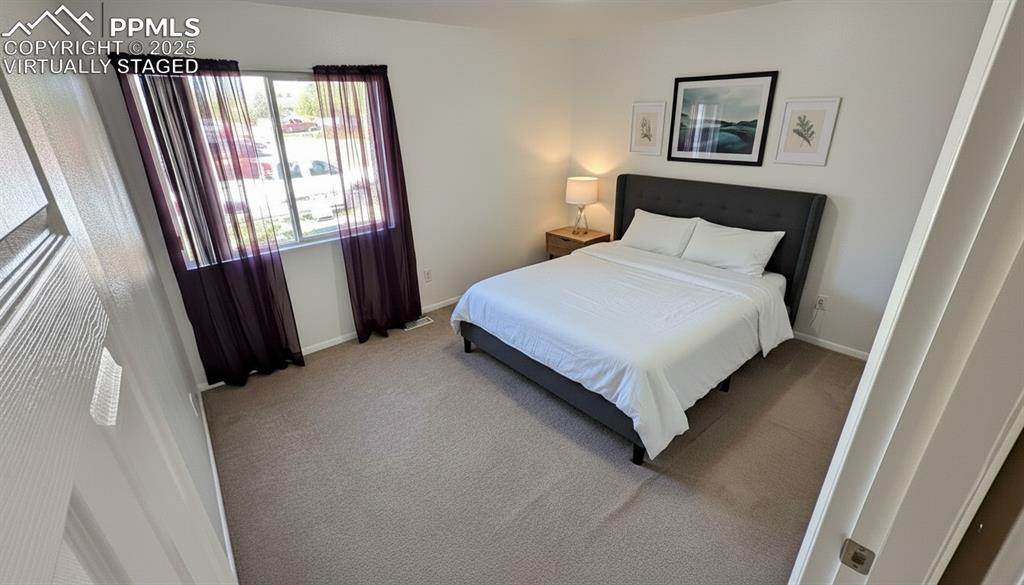 Image 24 of 34: Carpeted bedroom featuring baseboards. virtually staged