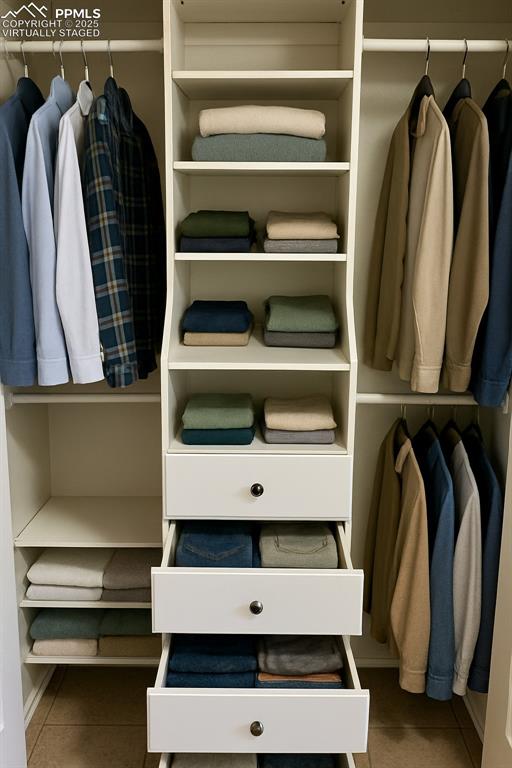 Image 26 of 34: View of primary closet. virtually staged