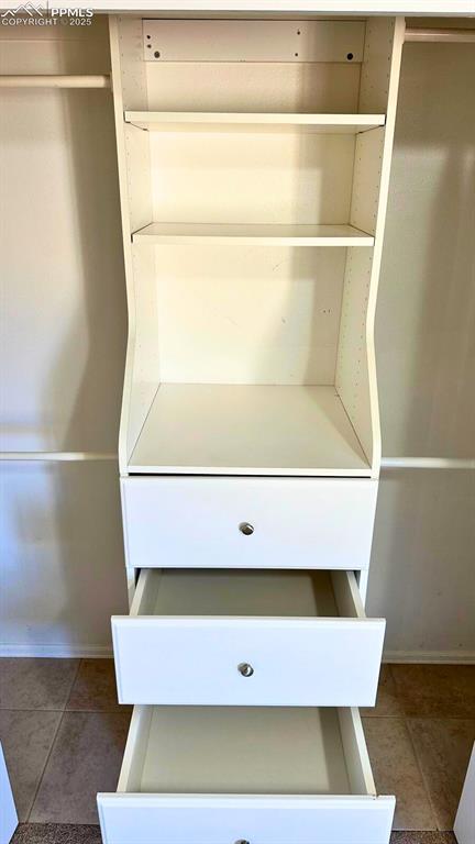 Image 27 of 34: View of primary closet.un-staged