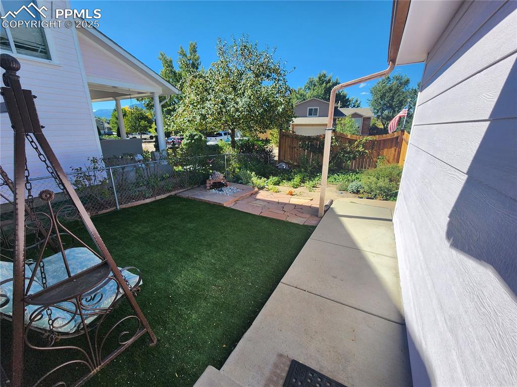 Image 5 of 34: Fully Fenced yard featuring a patio area. Porch Swing stays