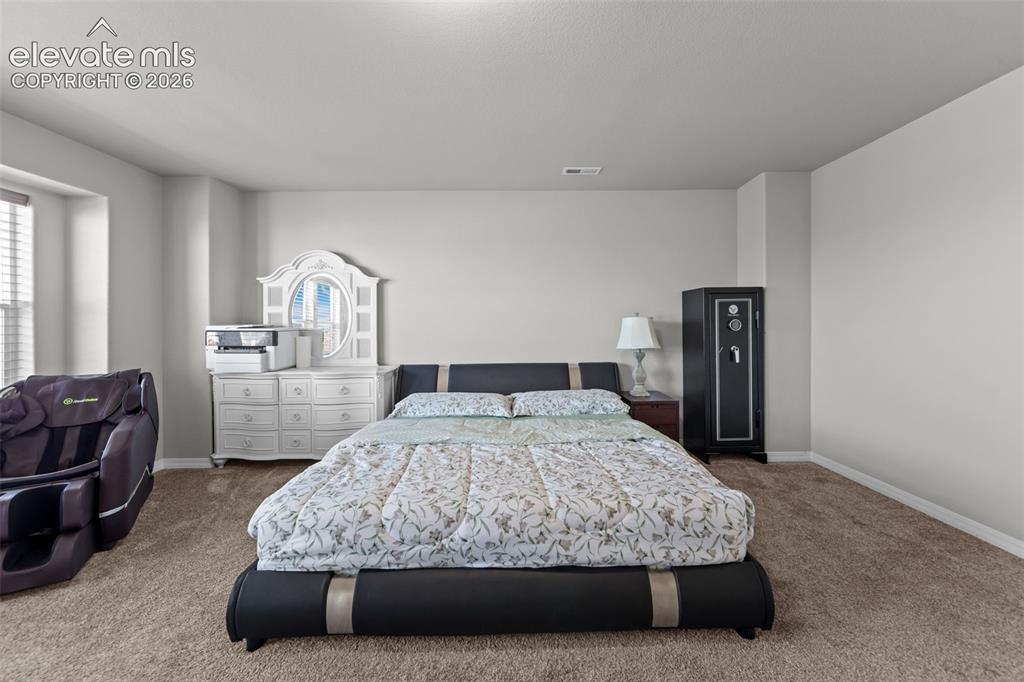 Image 15 of 41: Neutral wall color with textured carpeting