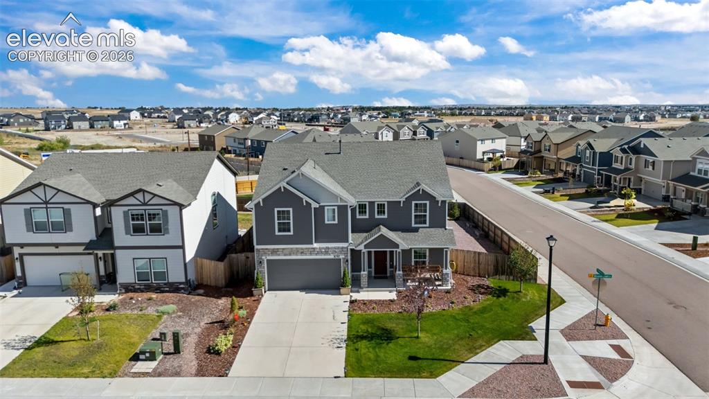 Image 31 of 41: Contemporary two-story residence with a covered front porch, an attached tw