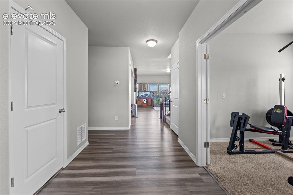 Image 5 of 41: Wood-finish flooring throughout the hallway