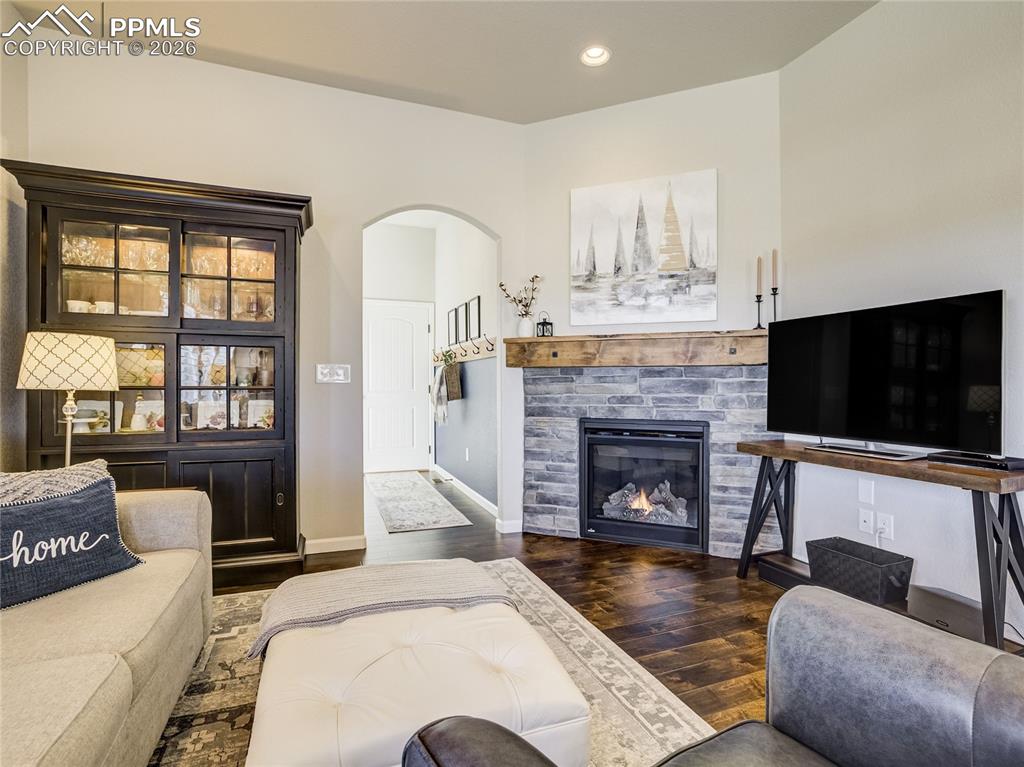 Image 3 of 45: Anchored by a beautifully detailed stone fireplace, this living room space 