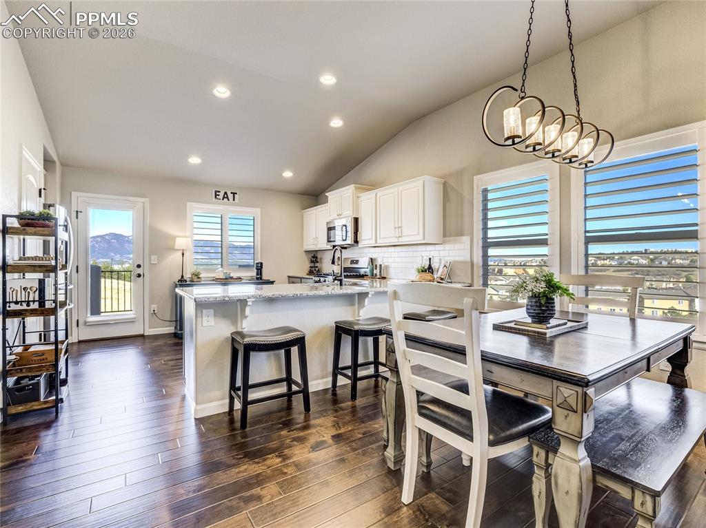 Image 5 of 45: Natural light pours through plantation shutters, framing mountain views and