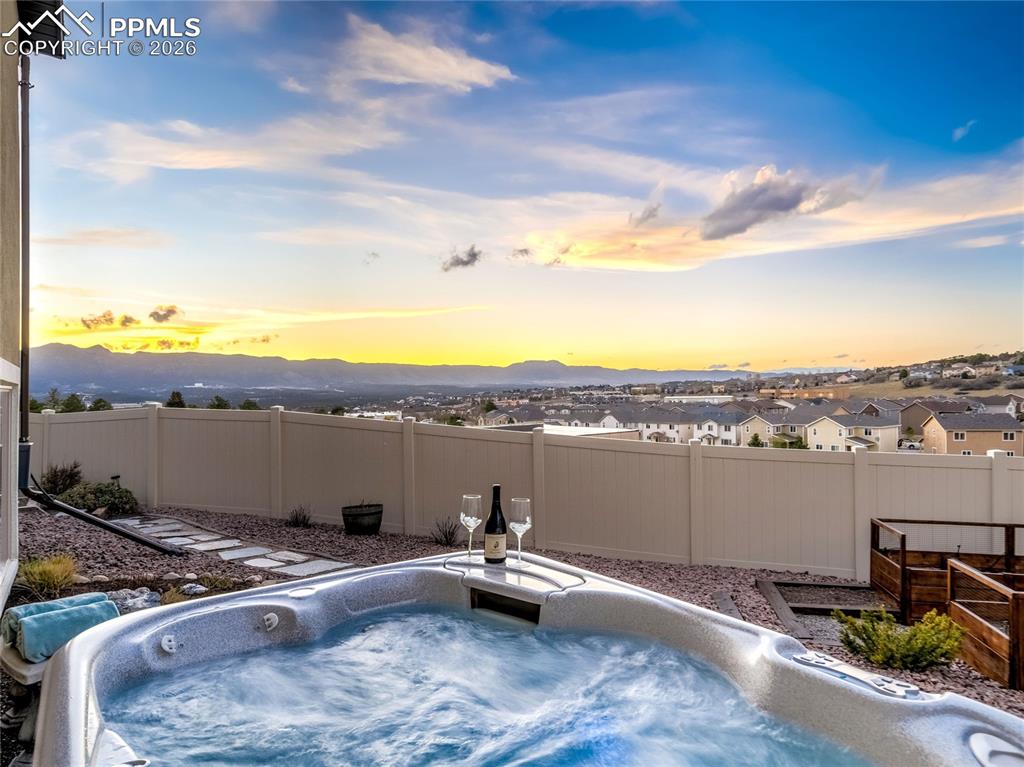 Image 7 of 45: Soak in the glow of Rocky Mountain sunsets from the private hot tub, where 