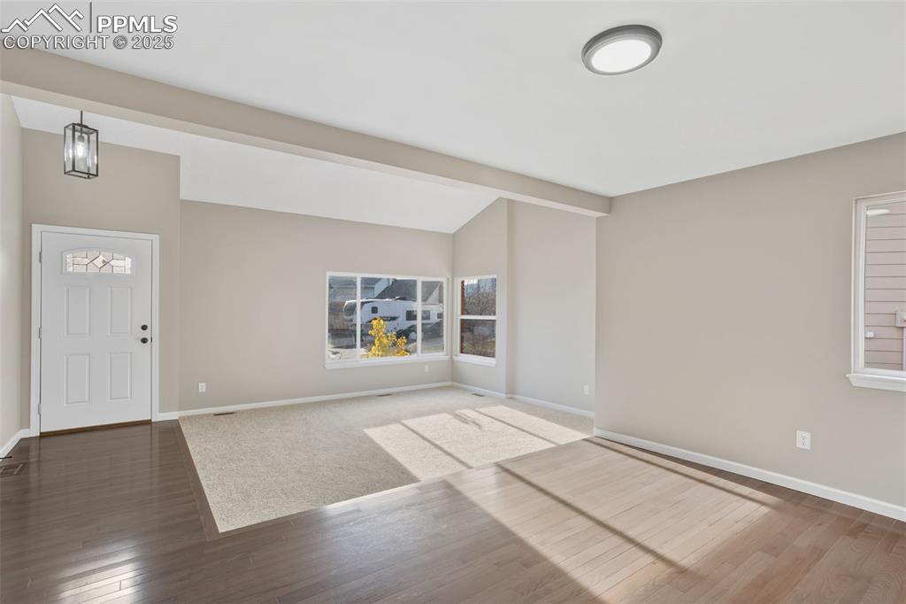 Image 9 of 31: Front living room and dining room, solid hardwood floor and carpet