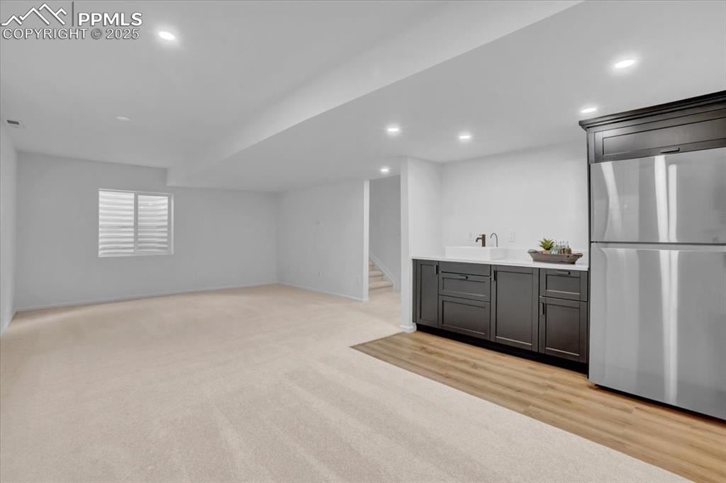 Image 6 of 36: Basement Family/Rec Room with wetbar & full fridge
