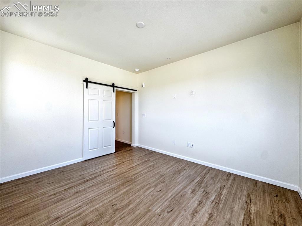 Image 20 of 29: Primary Bedroom with Barn Door
