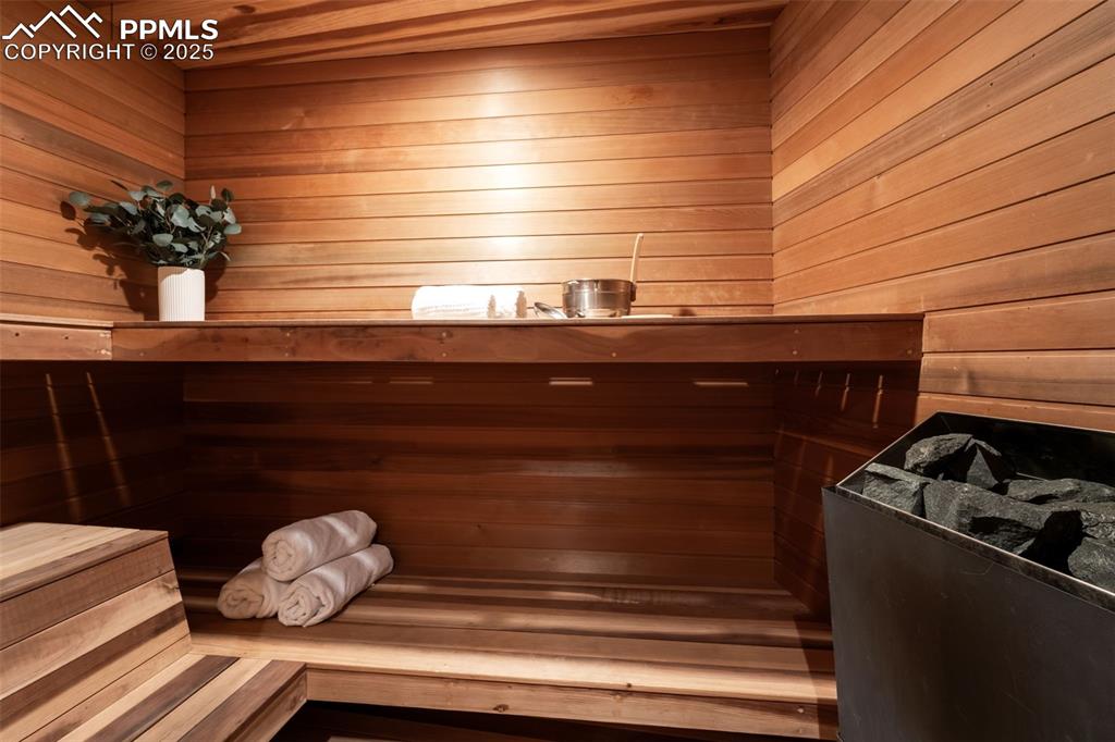 Image 33 of 39: Relaxing sauna featuring wood walls