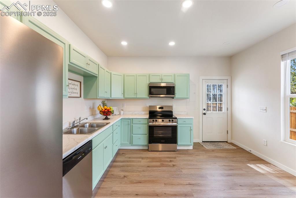 Image 11 of 42: The kitchen and ding area offer walk-out access to the back yard